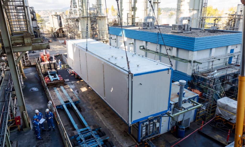 Modular building being positioned for installation at an industrial facility.